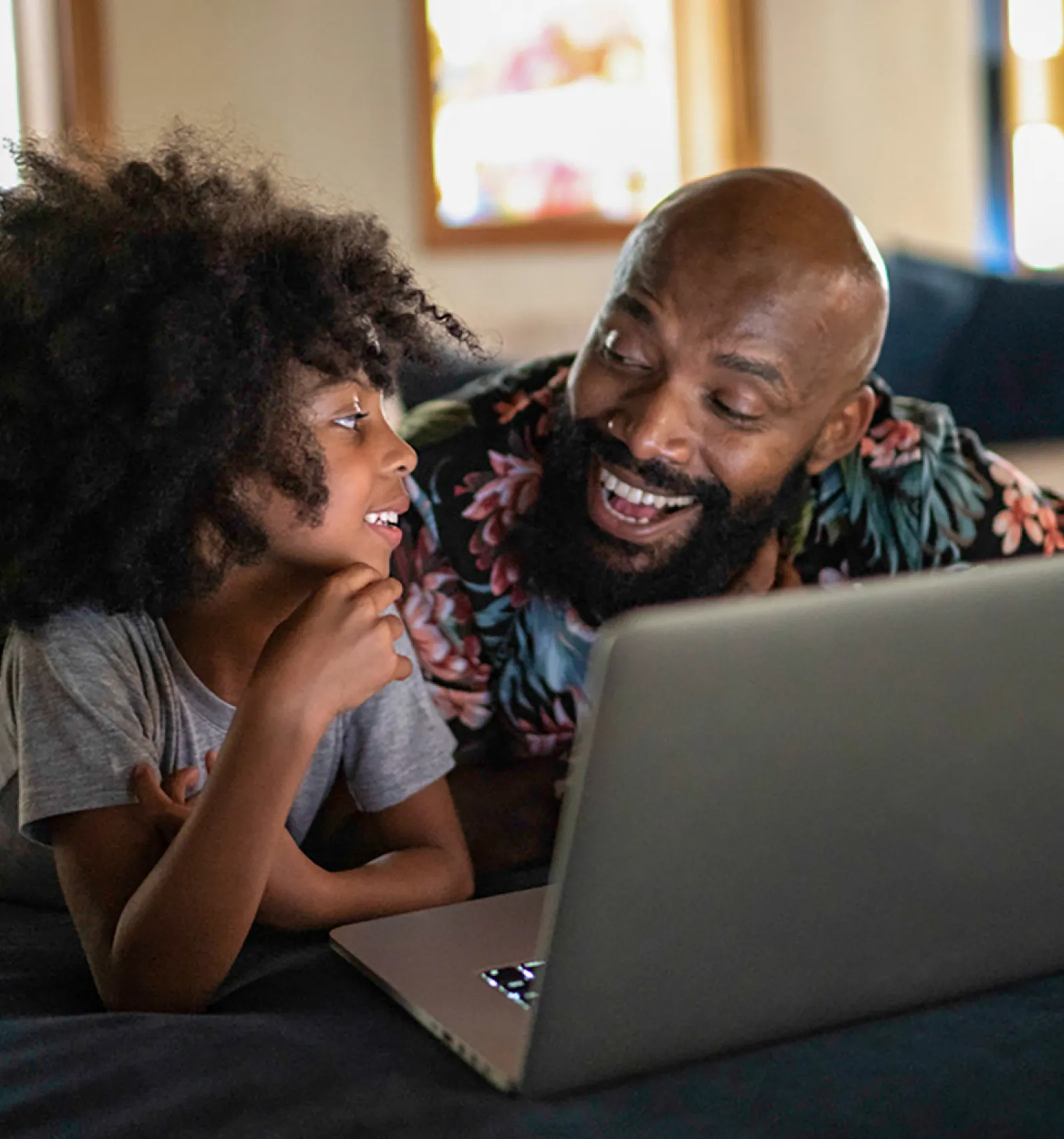 Father and son using laptop together.